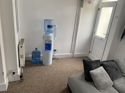 a living room with a large water cooler and a couch at Doubled bedroom in Portsmouth