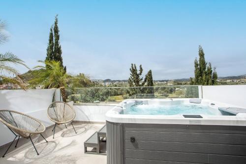 a hot tub on the balcony of a house at JnS Premium Stay in Faliraki