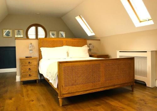 a bedroom with a large bed with a wooden headboard at The Loft at the Croft - Stunning rural retreat perfect for couples & dogs in Leigh