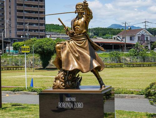 a bronze statue of a woman with a bow and arrow at Vessel Hotel Kumamoto Airport in Ozu
