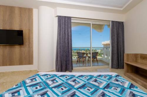 a bedroom with a bed and a view of the ocean at Seagull Beach Resort - Families and Couples Only in Hurghada