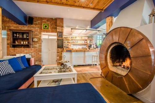 a living room with a fireplace in the middle of it at Domy na Wodzie na Mazurach in Pisz
