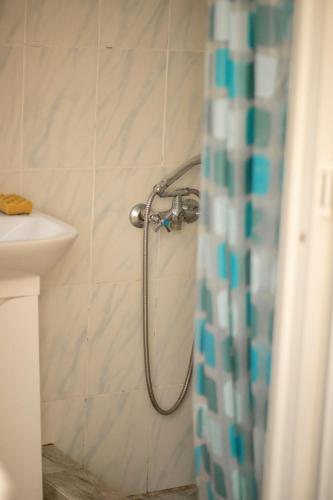 a shower in a bathroom with a shower curtain at Black Sea STAR in Chornomorsk