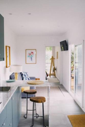 a kitchen with a counter and stools in a room at Casa Oliva - Casa do Lago in Porto de Mós