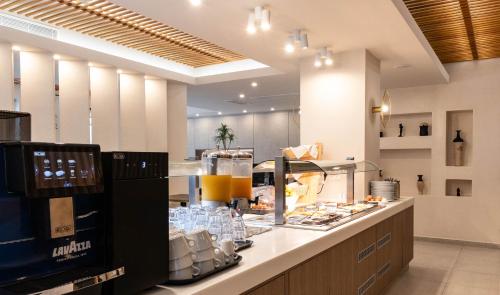 a kitchen with a counter with plates of food at Sellada Beach in Perissa