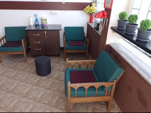 a waiting room with two chairs and a counter at TRIO sobe in Jajce