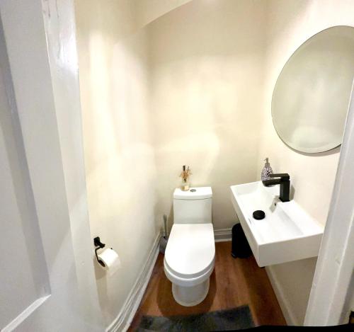 a bathroom with a white toilet and a sink at 10-A Diamond in Yonkers, NY in Yonkers