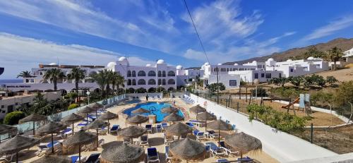 een uitzicht op een resort met stoelen en een zwembad bij Hotel El Puntazo I in Mojácar