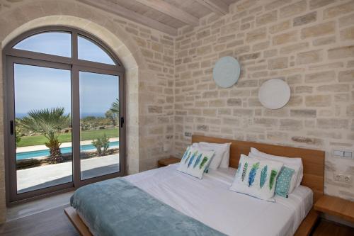 a bedroom with a bed and a large window at Villa Aurora in Prinés