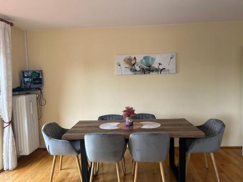 a dining room table with chairs and a wooden table at Albert-Schulte-Park Apartment- Worms in Worms