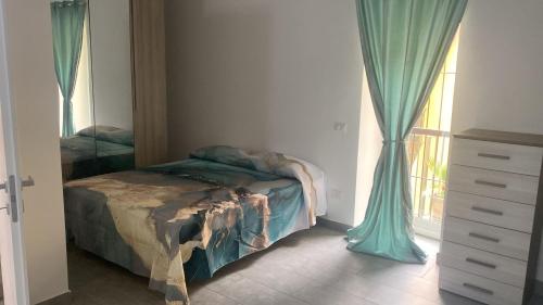 a bedroom with a bed and a window with curtains at Casa Vacanze Aversa centro 2 in Aversa