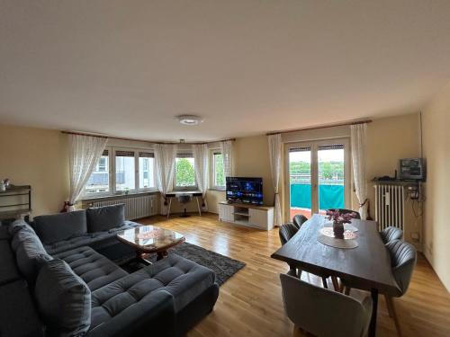 a living room with a couch and a table at Albert-Schulte-Park Apartment- Worms in Worms