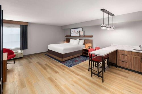 a hotel room with a bed and a desk at Hawthorn Extended Stay by Wyndham Knoxville in Knoxville