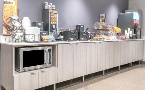 a counter with a microwave on top of it at Spark by Hilton Rochester South in Rochester