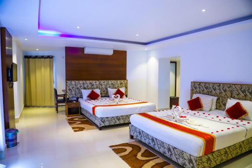 A bed or beds in a room at Panshi Inn Sylhet