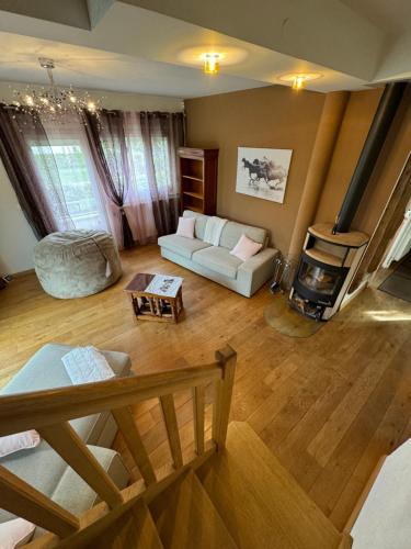 a living room with a white couch and a fireplace at Maison familiale, professionnel 10min CERN Genève in Saint-Genis-Pouilly