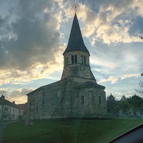 an old church with a steeple on top of it at La Roulotte De Lola - Chambre d'hôtes in La Celle
