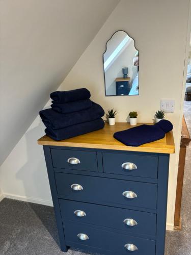 a blue dresser with a mirror on top of it at POSTBOX CROFT With A Sea View in Armadale
