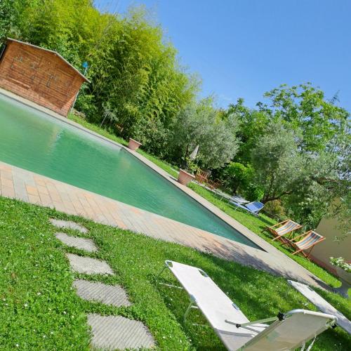 a swimming pool with two lounge chairs in the grass at Guest House Torre Guelfa, Vinsantaia in Figline Valdarno