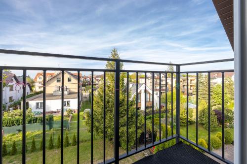 a balcony with a view of a yard at DG Albatros II in Rewal