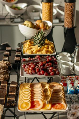 a table with several trays of different types of food at Rest&Ski Spa Resort in Bukovel