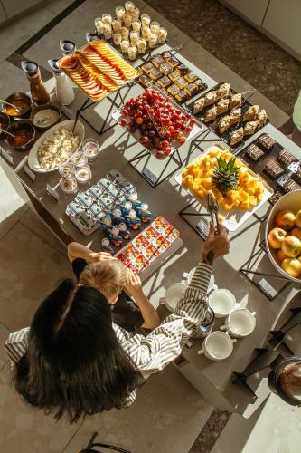 a group of people sitting at a table with food at Rest&Ski Spa Resort in Bukovel