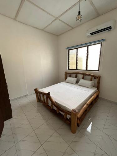 a bedroom with a bed in the middle of a room at Beautiful house in Oxford street KFC in Accra