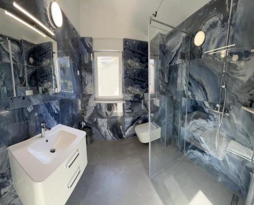 a bathroom with a sink and a glass shower at Villa Blaga in Sevid