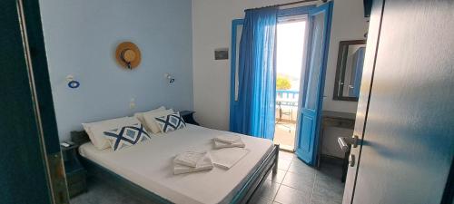 a bedroom with a bed and a door with a window at Studio Elisabeth in Agios Ioannis