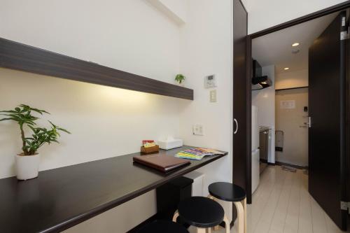 a room with a desk and stools in a room at 錦系町天空樹景觀飯店 Skytree View Kinshicho in Tokyo