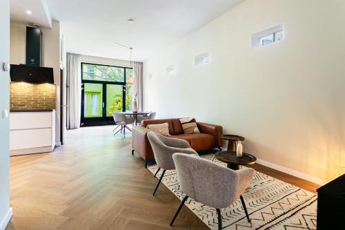 a living room with a couch and chairs and a table at Stylish apartment next to the Amstel River - Unit A in Amsterdam