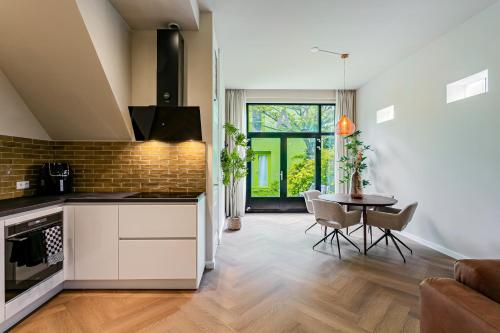 a kitchen and living room with a table and chairs at Stylish apartment next to the Amstel River - Unit A in Amsterdam