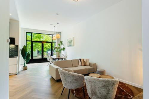 a living room with a couch and a table at Stylish apartment next to the Amstel River - Unit C in Amsterdam