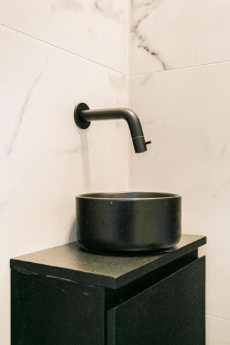 a black pan sitting on top of a black stand at Stylish apartment next to the Amstel River - Unit C in Amsterdam