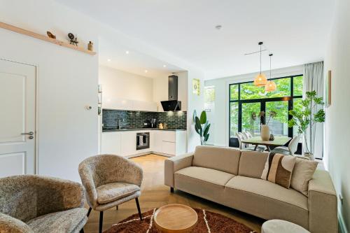 a living room with a couch and chairs and a table at Stylish apartment next to the Amstel River - Unit C in Amsterdam