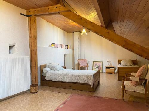 une chambre avec un lit et une chaise dans une pièce dans l'établissement Au coeur des volcans, à Ceyssat