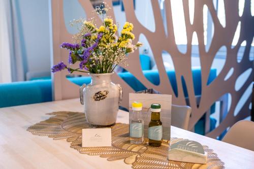 a vase filled with flowers sitting on top of a table at Paradisos in Frangokastello