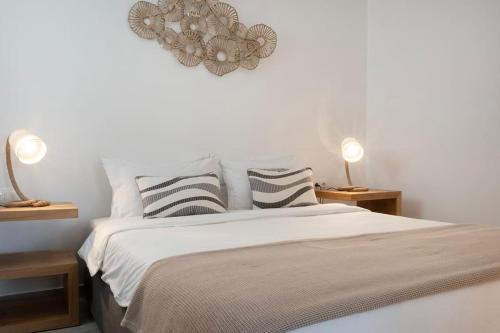 a bedroom with a large bed with pillows and a heart at Ornos Vibes 1 in Mikonos