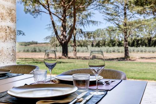 a table with two glasses of wine on it at Domaine de Panery in Pouzilhac