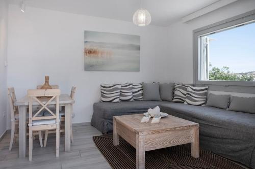 a living room with a couch and a table at Ornos Vibes 1 in Mikonos