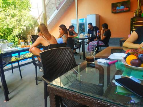 a group of people sitting at tables in a restaurant at Red Hotel Yerevan Center in Yerevan