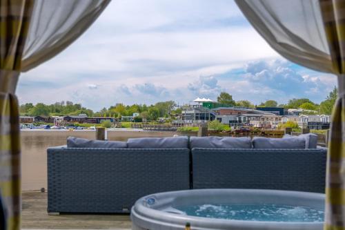 a view of the water from a patio with a hot tub at Lake View with Private Hot Tub at Tattershall Lakes in Tattershall