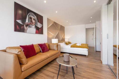 un salon avec un canapé et un lit dans l'établissement Village Naturiste R4N - Le White&Sea Héliopolis, au Cap d'Agde