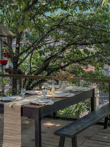 a wooden table with wine glasses on a wooden deck at Love House Homestay SAPA in Sa Pa