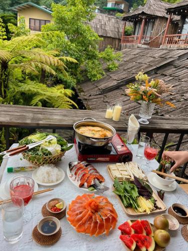 a table with sushi and other food on it at Love House Homestay SAPA in Sa Pa