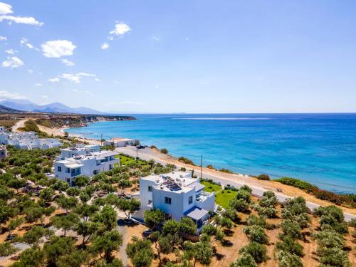 an aerial view of a beach with white buildings and the ocean at Paradisos in Frangokastello