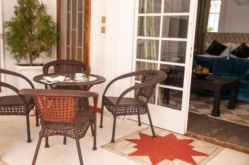 a patio with chairs and a table with a star on the floor at Coconut Residence & Spa in Kololi