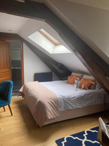 a bedroom with a bed with an attic at Domaine De Barive in Sainte-Preuve