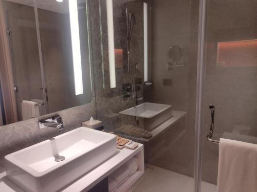 a bathroom with a white sink and a shower at Hyatt Centric Hebbal Bengaluru in Bengaluru