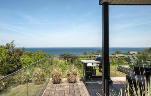a balcony with a view of the ocean at Gorgeous Home In Asnæs With Sauna in Asnæs